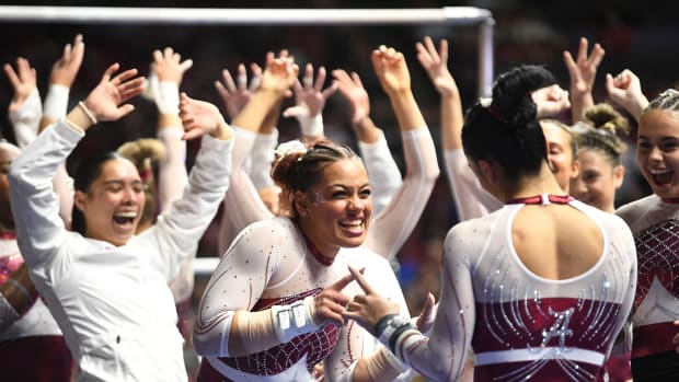 Alabama gymnast Makarri Doggette congratulates Alabama gymnast Luisa Blanco after Blanco s bars routine at Coleman Coliseum